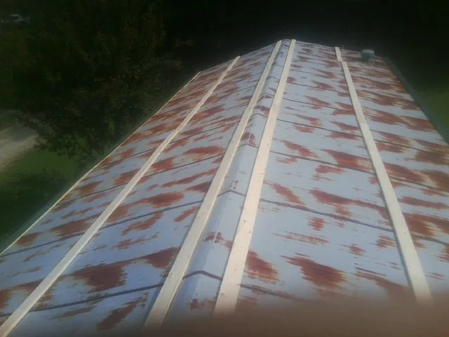 Rusted metal roof panels with new wood purlins before replacement — Storm Damage Roof Repair in Templeton by Roofing Brothers