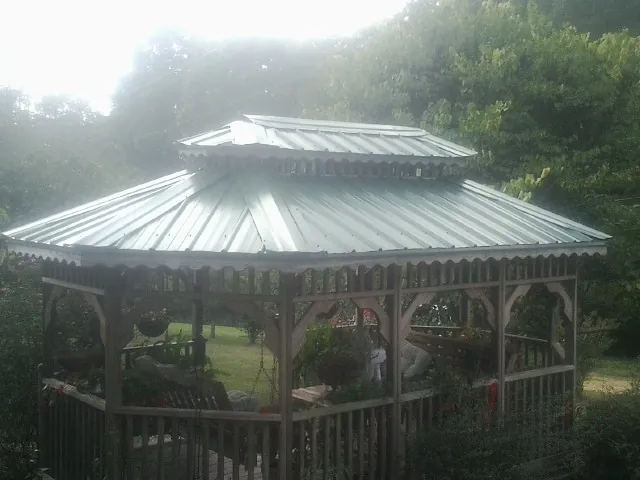 Two tier green metal roof on a garden gazebo in Templeton